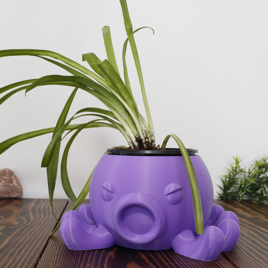 Small purple indoor planter pot in the shape of a cute angry octopus